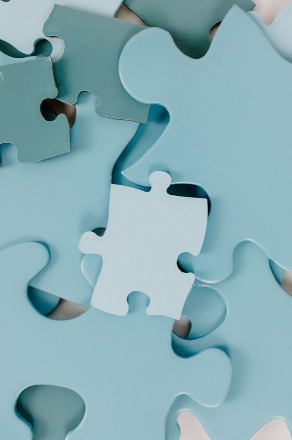 Scattered puzzle pieces, representing tailored business coaching solutions