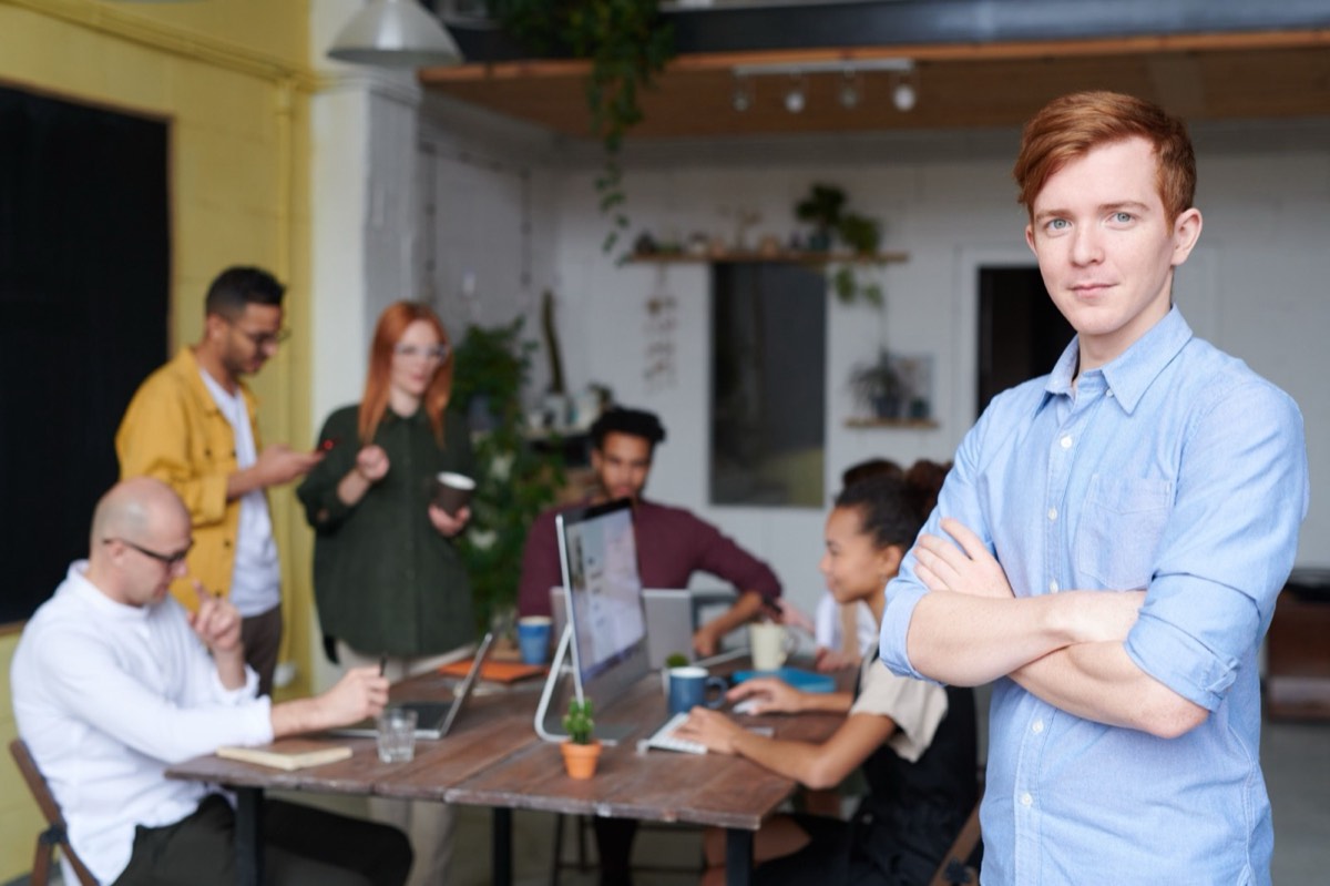 Confident professional in a team meeting, representing individual coaching
