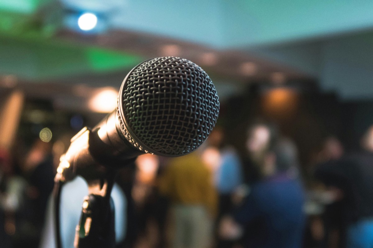 Speaker addressing an audience, representing public speaking coaching